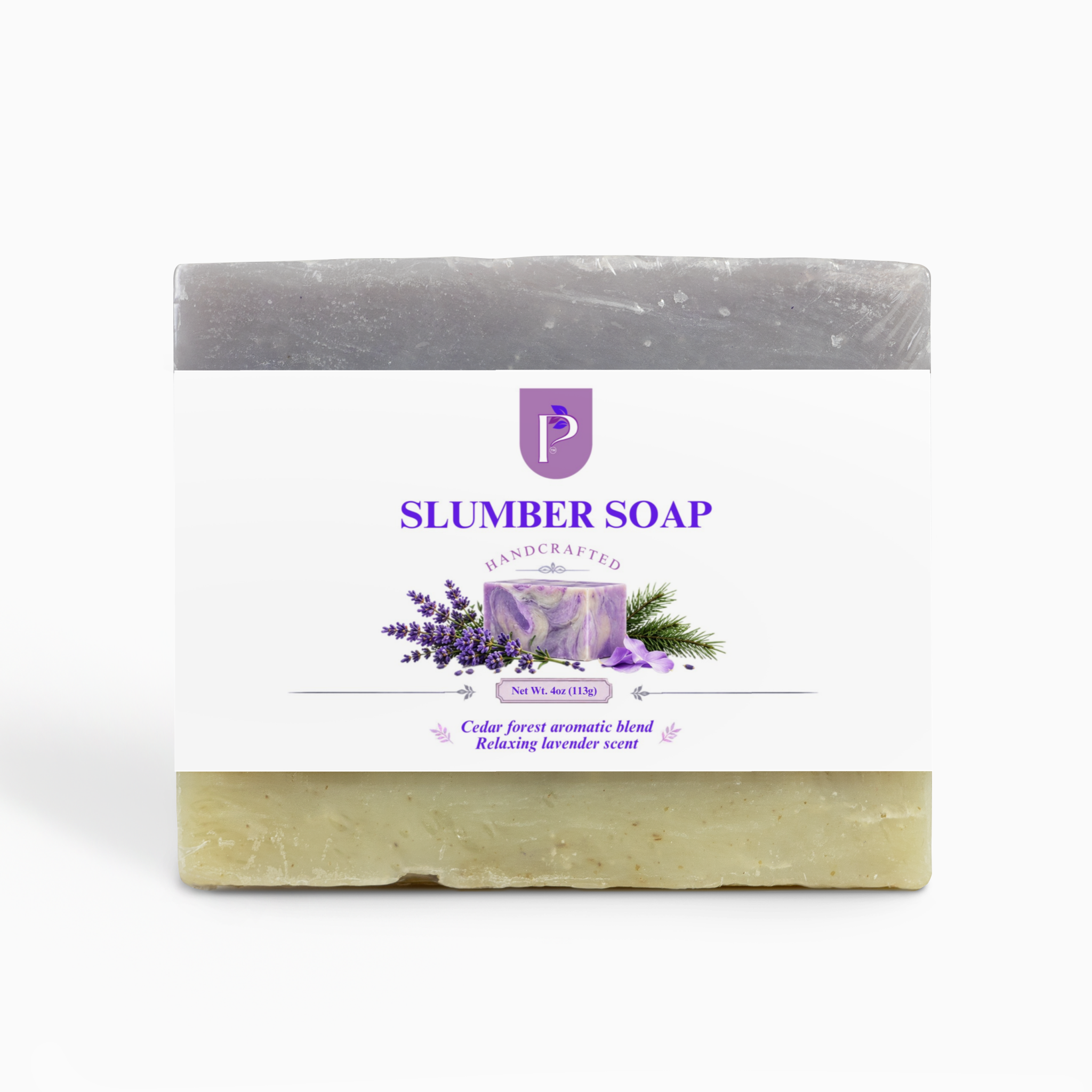 A rectangular bar of soap with a white paper label reading 'SLUMBER SOAP' and 'Handcrafted'. The top half of the soap is gray, and the bottom half is a pale yellow-green with visible botanical flecks.