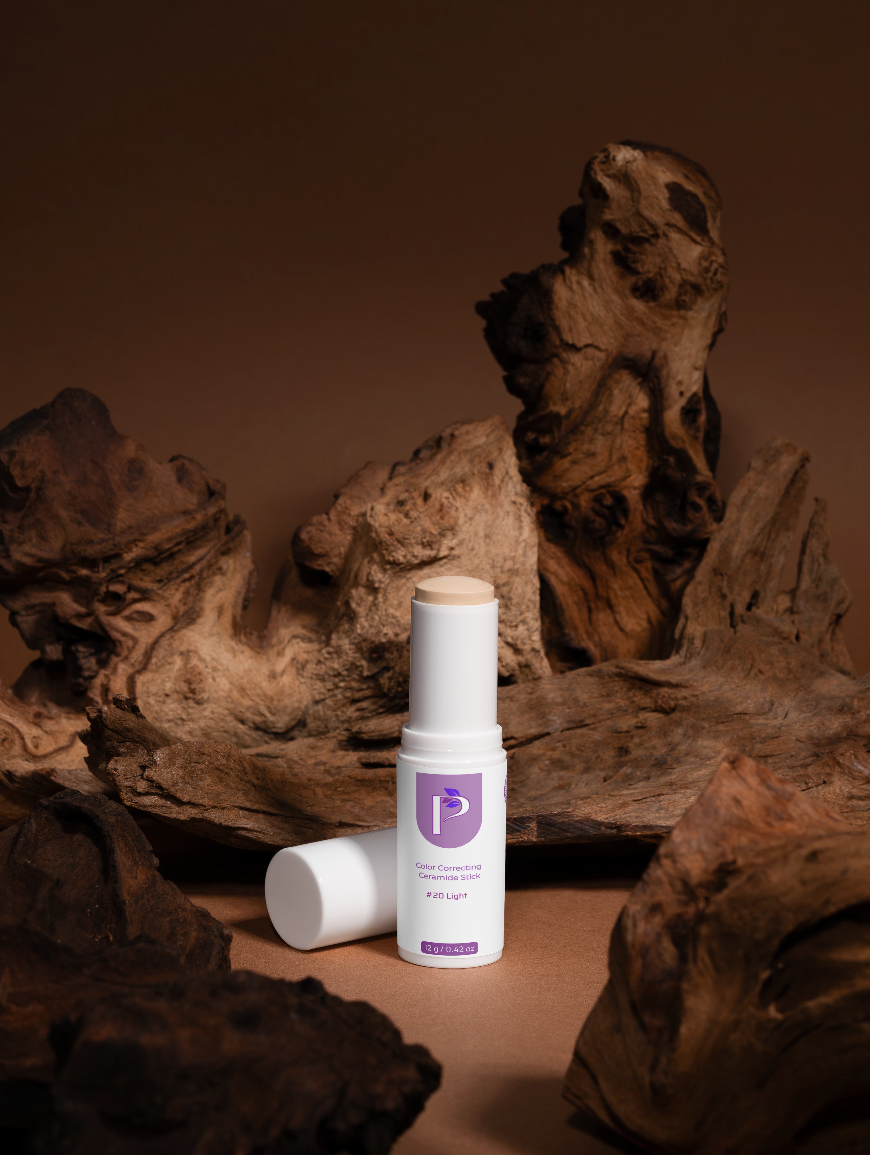 Two skincare bottles on a wooden surface with a brown background
