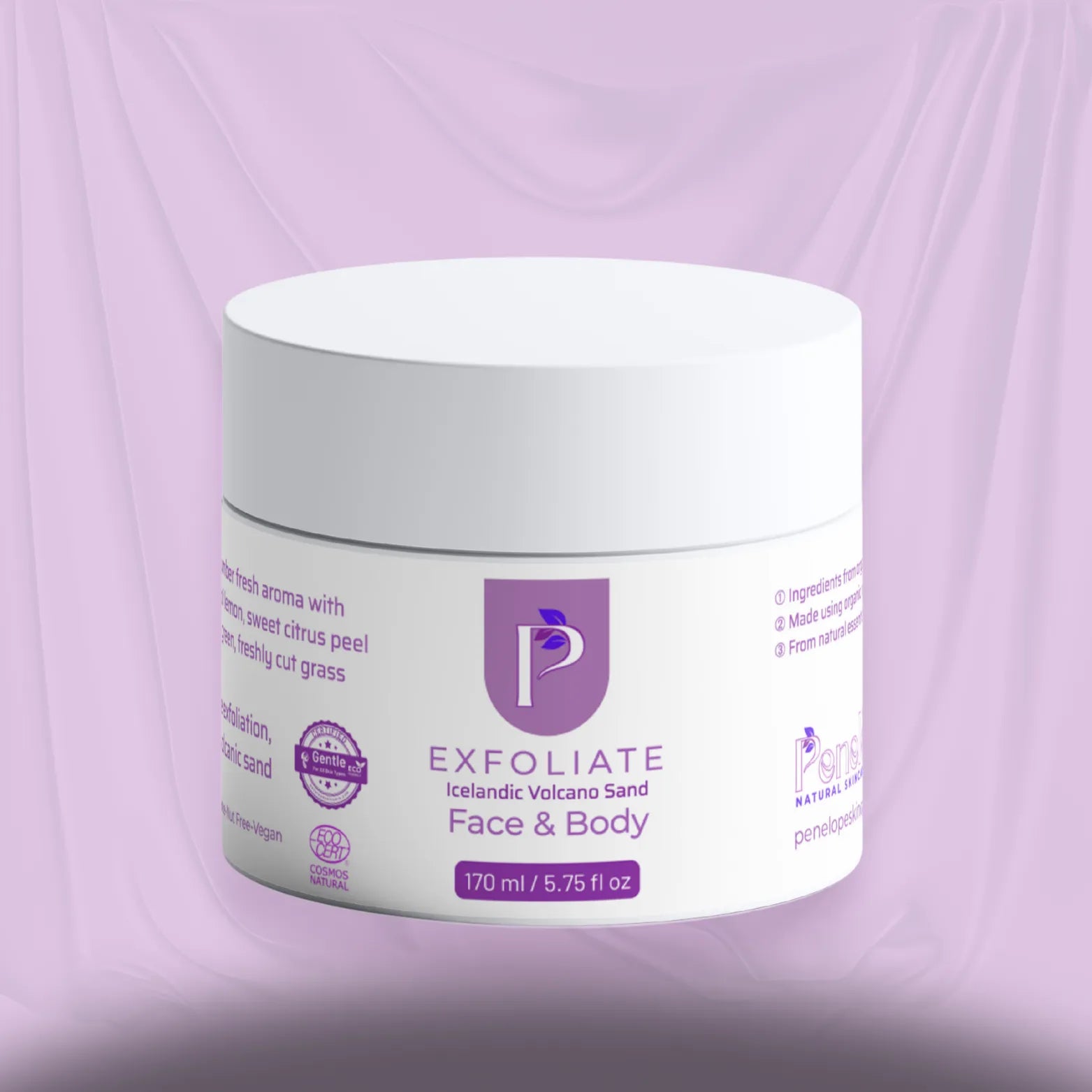 A white plastic jar of Exfoliate Face & Body cream with a purple logo and text, set against a draped lavender background.