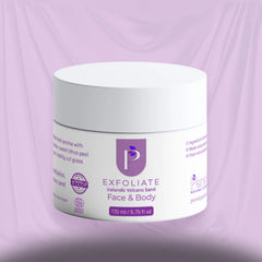 A white plastic jar of Exfoliate Face & Body cream with a purple logo and text, set against a draped lavender background.