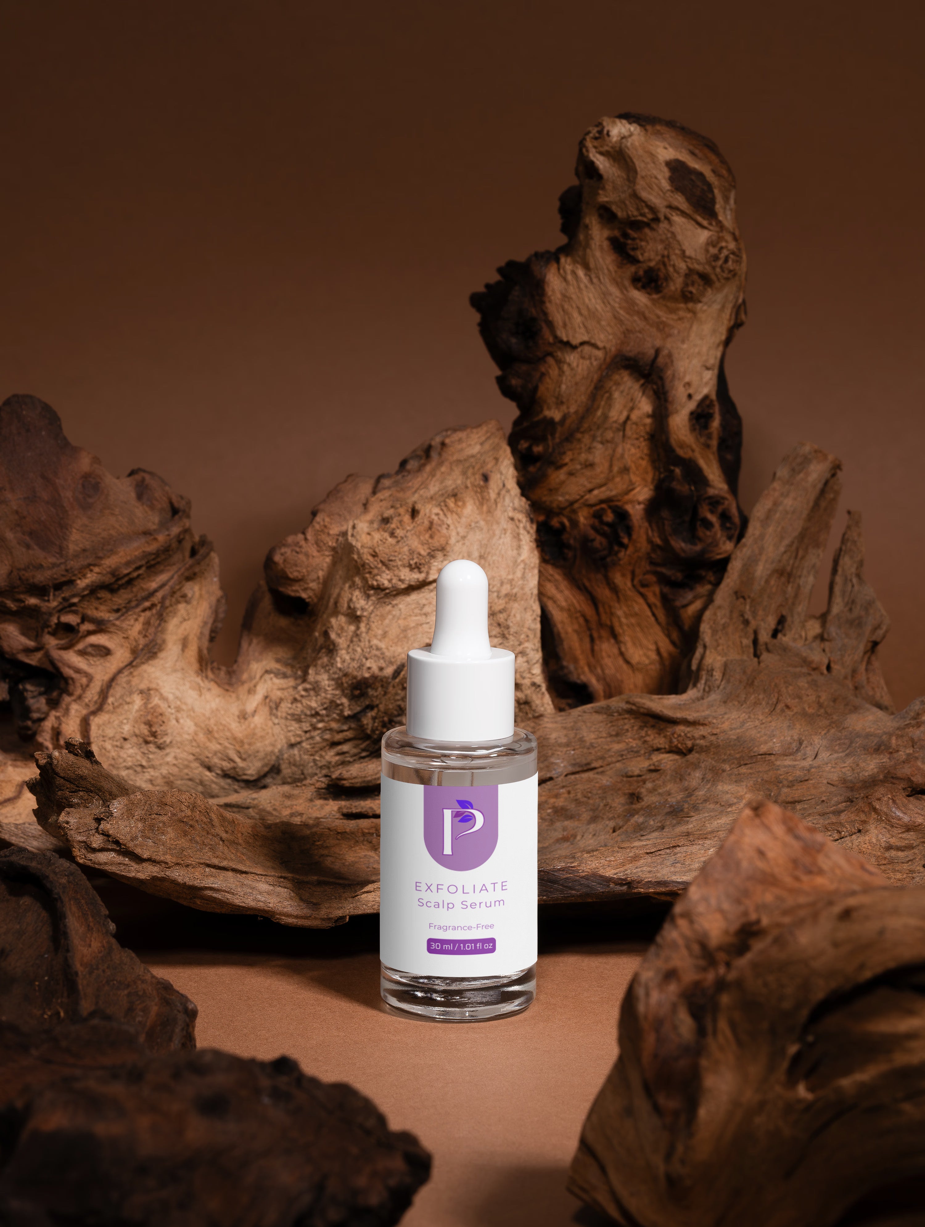 Skincare serum bottle with dropper on a brown background