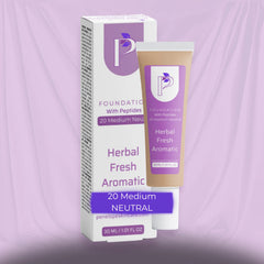 A cosmetic foundation tube labeled 'Foundation With Peptides Herbal Fresh Aromatic' stands in front of its matching retail box. The packaging is white with lavender-purple branding and text, and the tube body is a warm beige/tan.