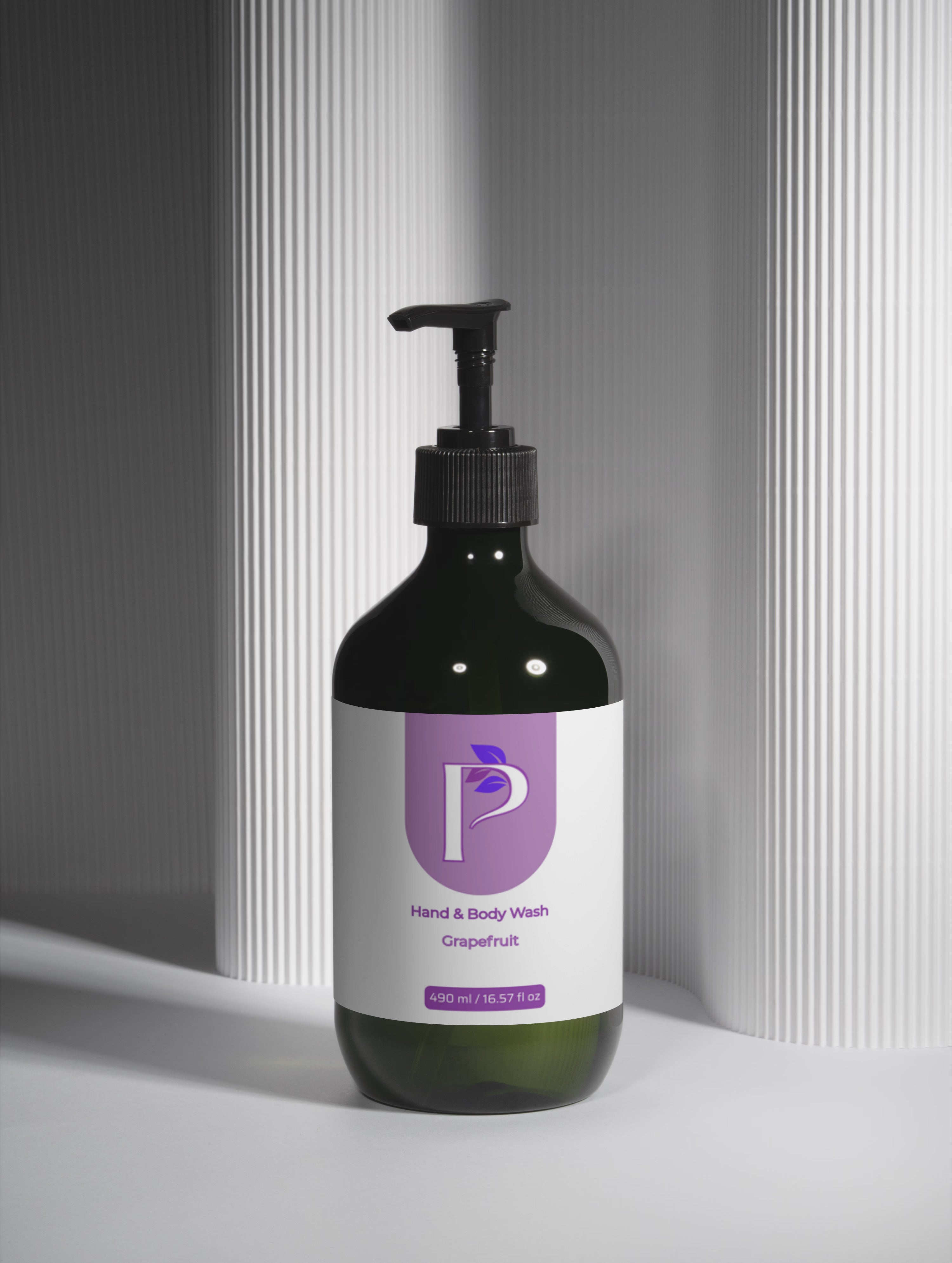 Bottle of Ganaé shower gel with a pump on a neutral background
