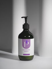 Bottle of Ganaé shower gel with a pump on a neutral background