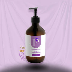 A 250 ml amber brown pump bottle of hand and body wash with a black dispenser, featuring a white and purple label, set against a draped lavender fabric background.