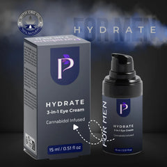 A bottle and box of HYDRATE 3-in-1 Eye Cream for men, featuring a dark gray and black design with a purple shield logo and white text, set against a dark smoky background.