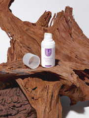 White bottle labeled eye cream on a wooden surface
